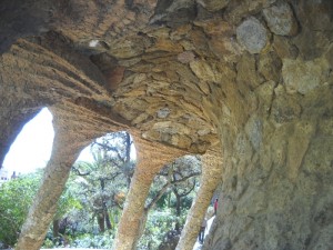 Tunnel sous un toit de pierre avec des colonnes à gauche (avec des raies)...
